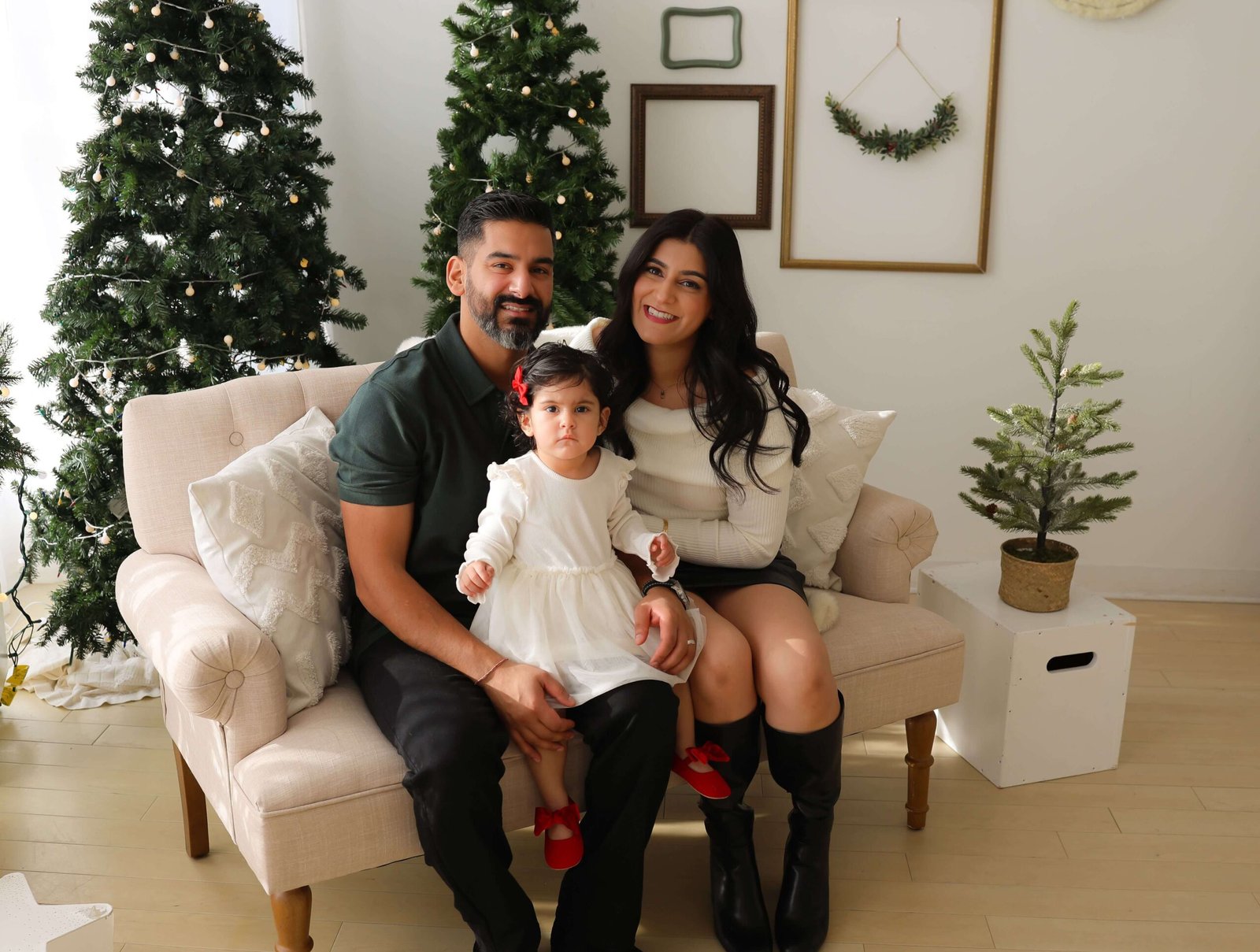 Parents and daughter dressed up for holiday portraits
