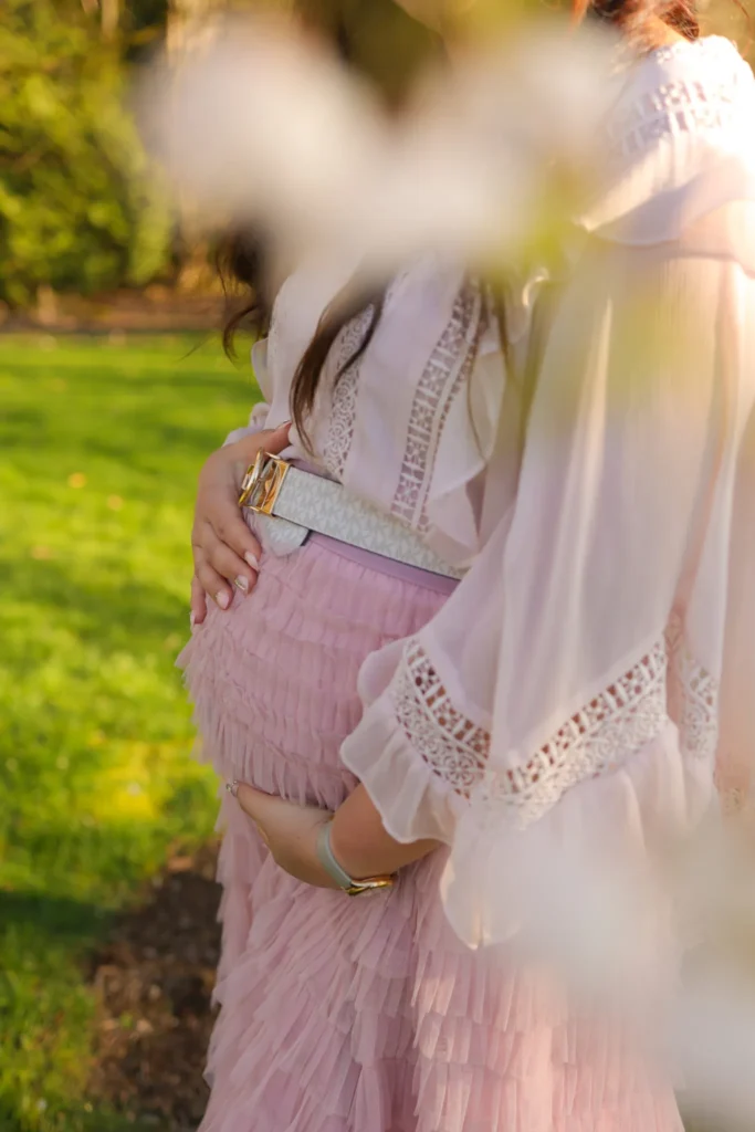 Close up maternity portrait with hands resting on belly