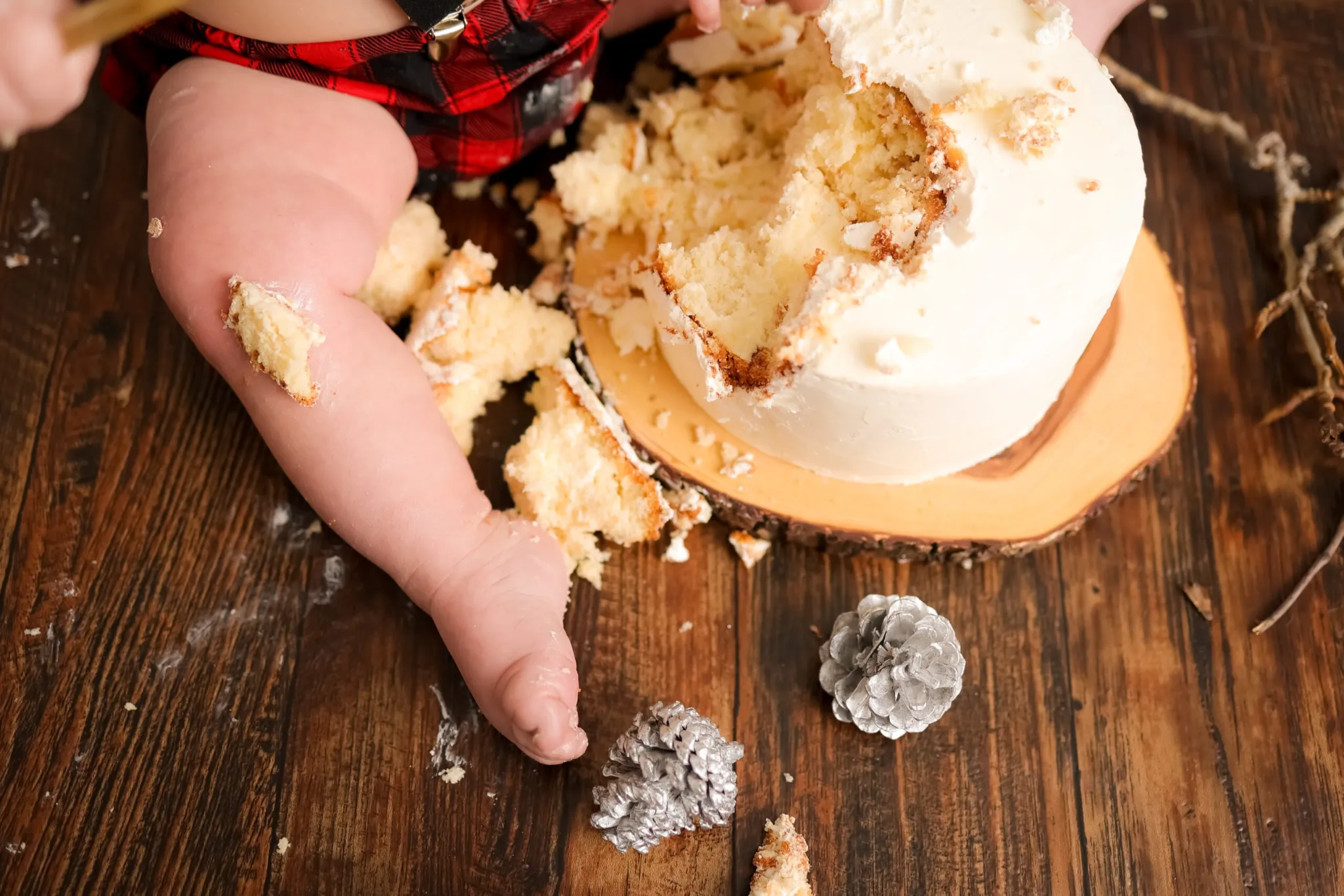 Close up of baby hands covered in cake frosting