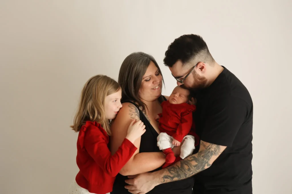 Parents hugging children closely during family portrait