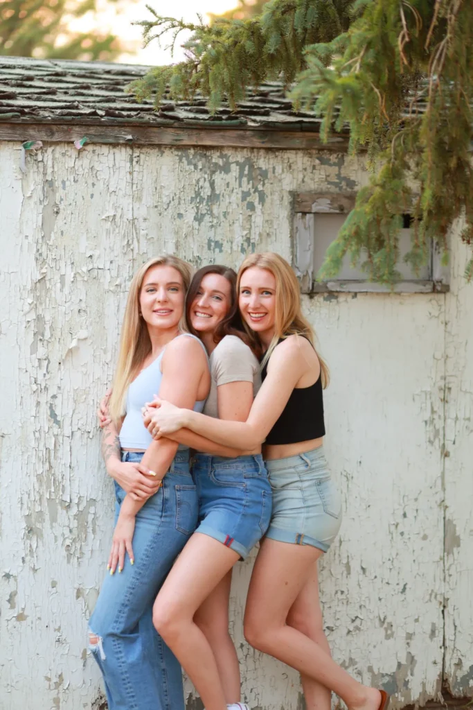 Three women standing together smiling during portrait session