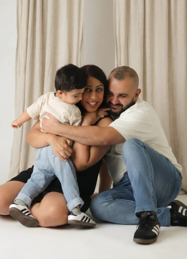 family hugging studio portrait