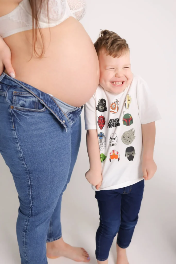 maternity belly photo with toddler scaled 1