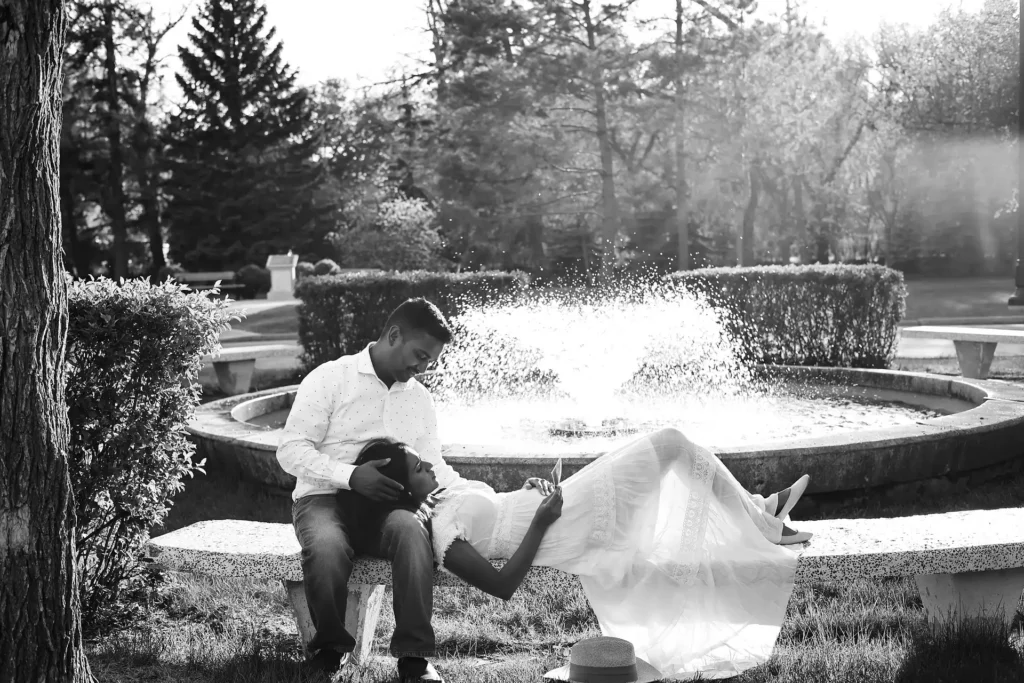Black and white photo of expecting couple sharing a quiet moment outdoors.jpg