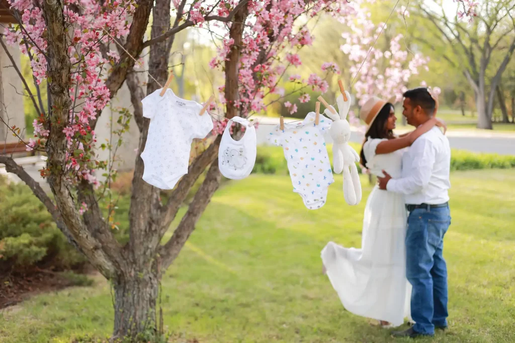 Expecting couple embracing outdoors during maternity photography session.jpg