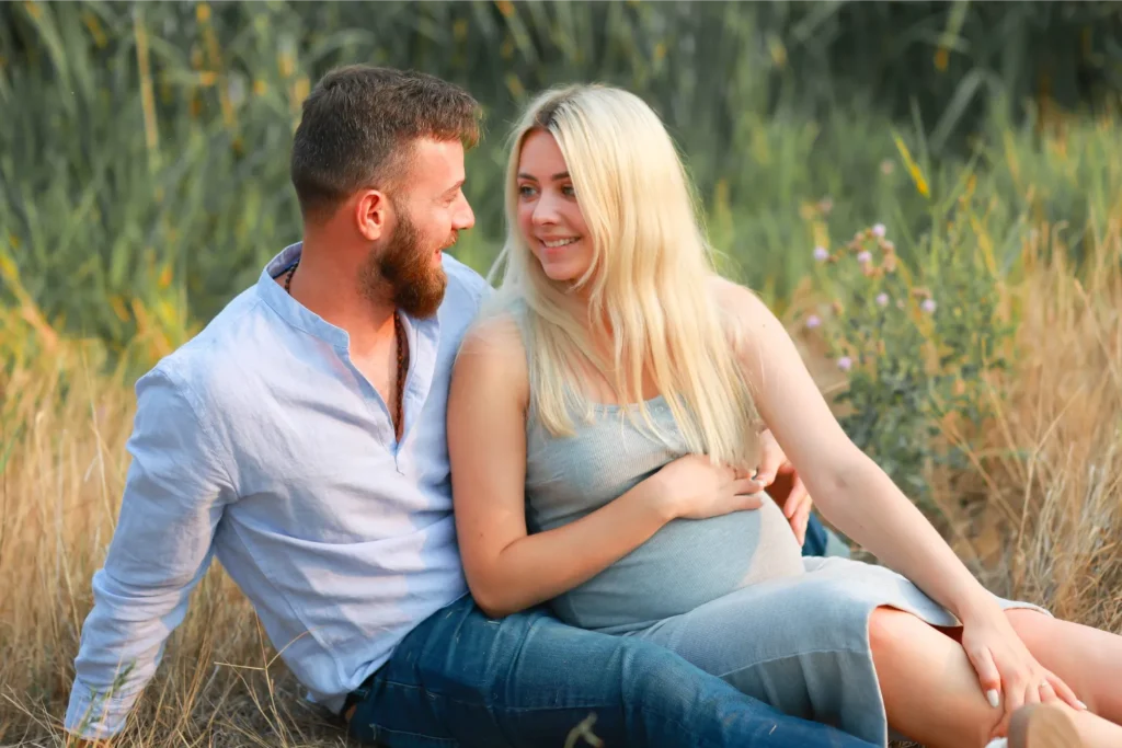 couple sitting grass sunset portrait