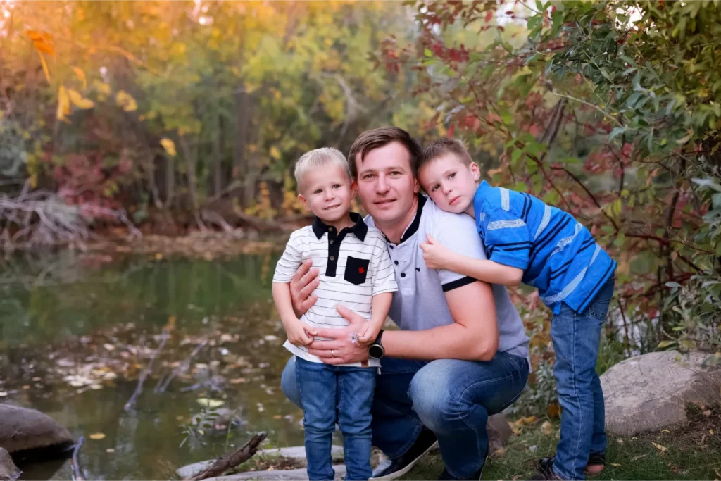 family sitting by lake portrait
