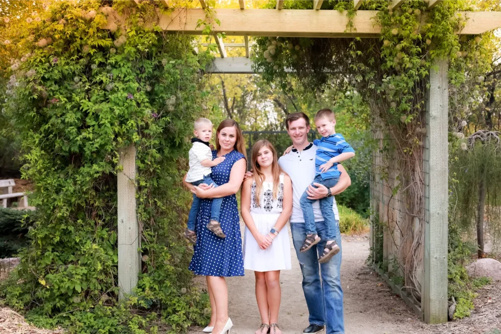 family under garden archway
