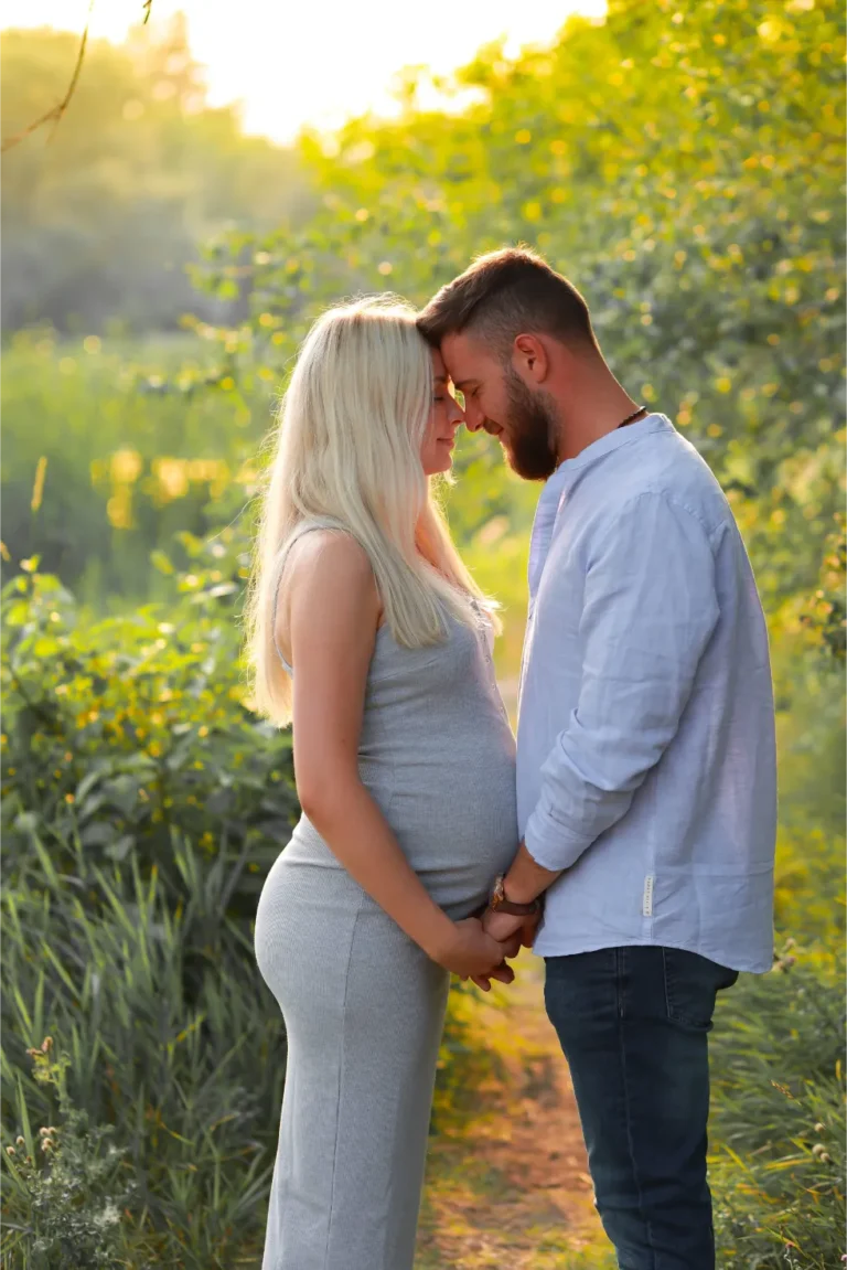 maternity couple sunset field