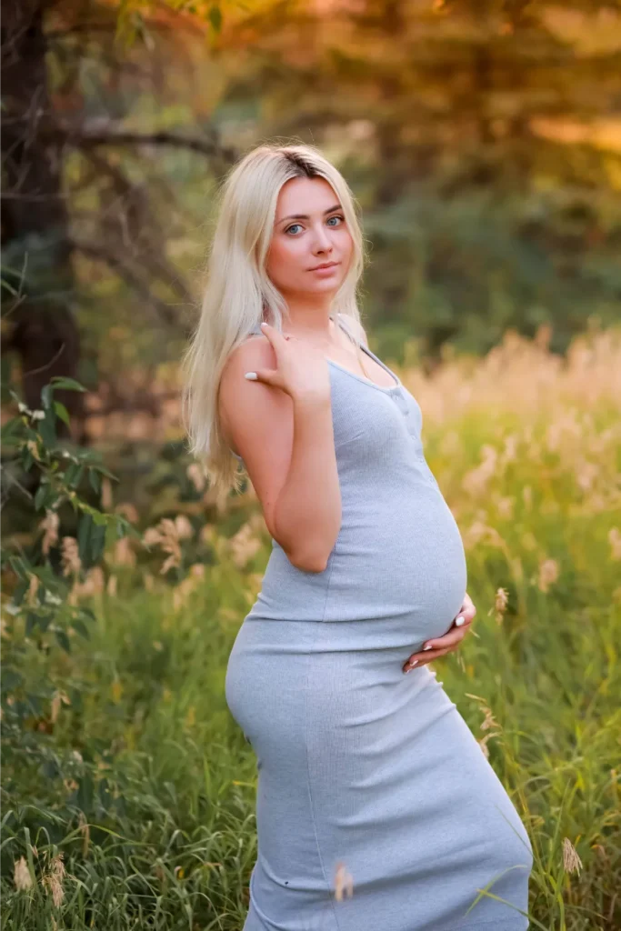 pregnant woman blue dress field