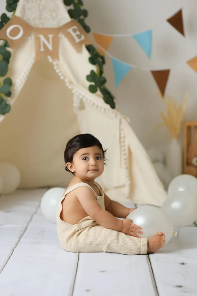 baby boy sitting under one banner
