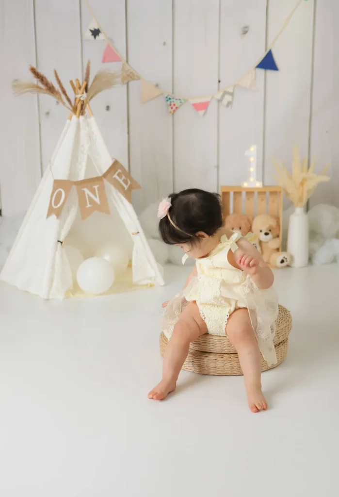baby girl sitting teepee first birthday
