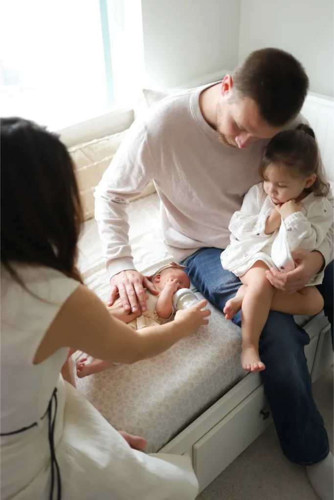 family sitting on bed lifestyle portrait