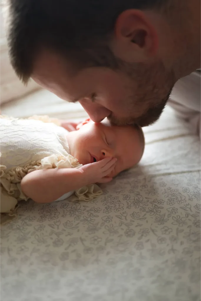 father kissing baby lifestyle session