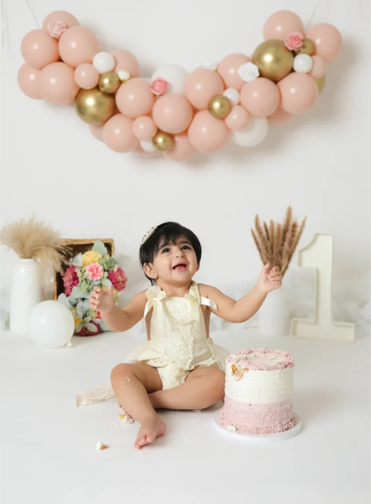 first birthday baby girl cake smash pink balloons