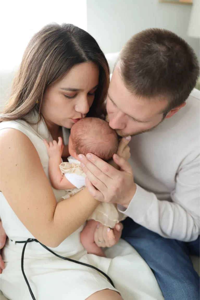 parents holding newborn baby close portrait