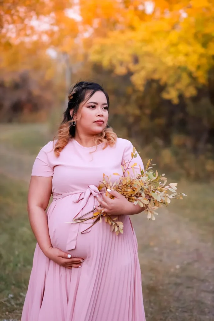 pregnant woman holding flowers fall