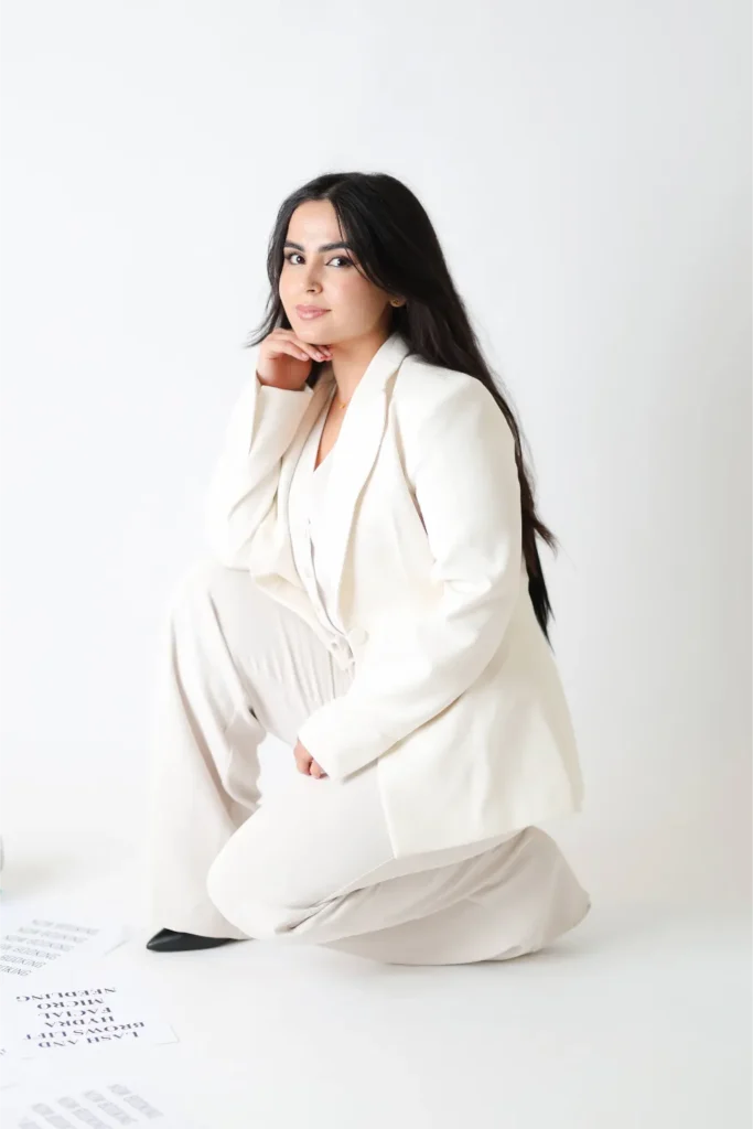 woman in white suit minimal studio portrait