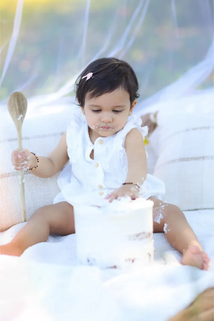 baby sitting white outfit portrait