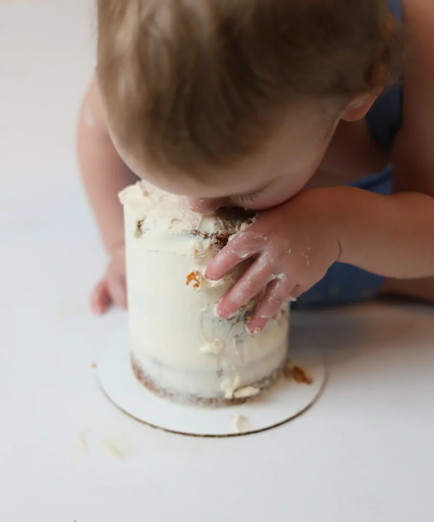 Baby boy mid cake smash session in blue boho teepee setup, Abbotsford photographer