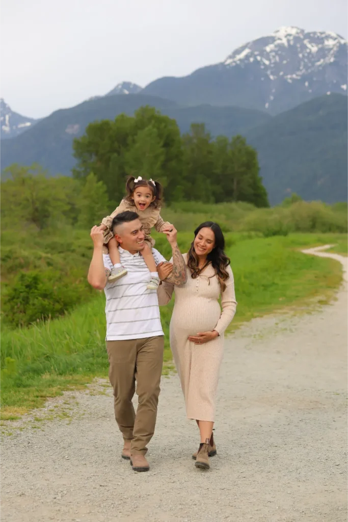 family walking mountain trail maternity session