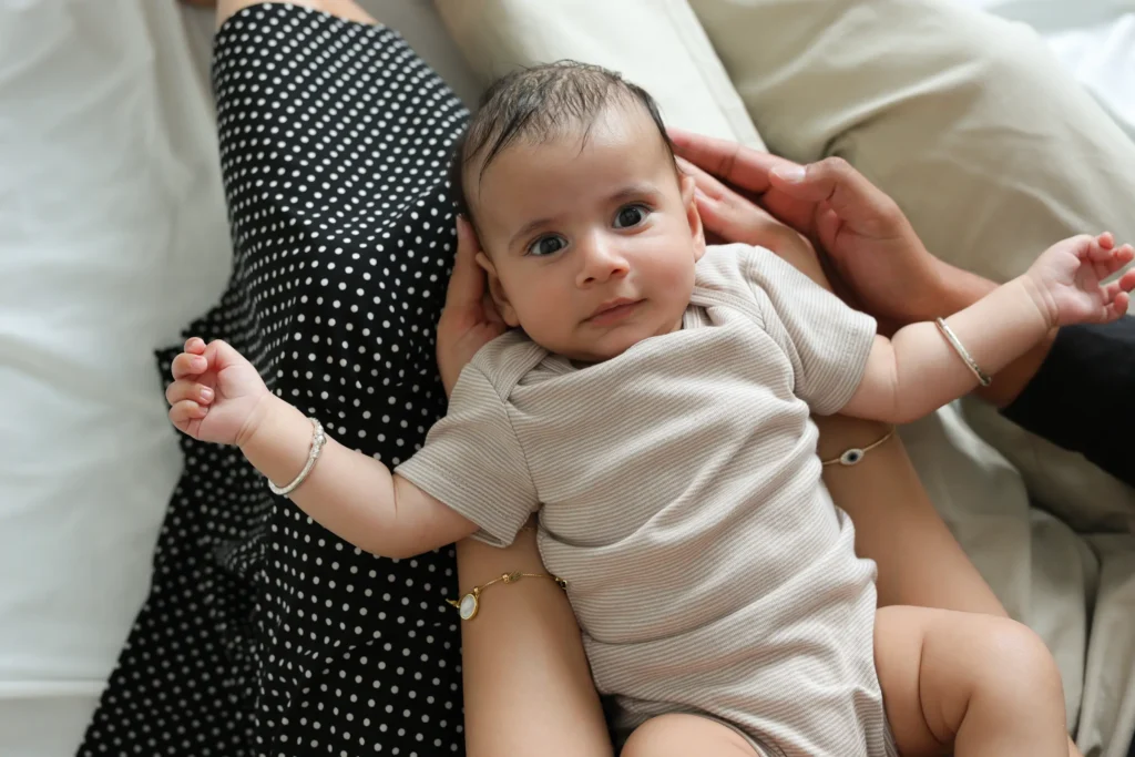newborn held by parents