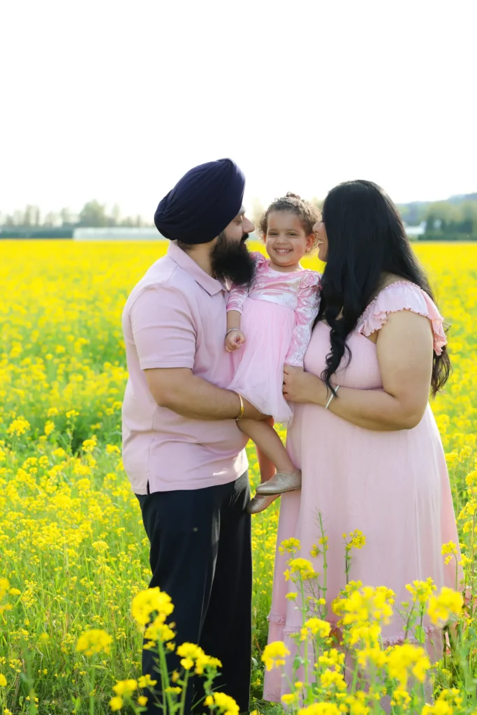 couple maternity session yellow flower field