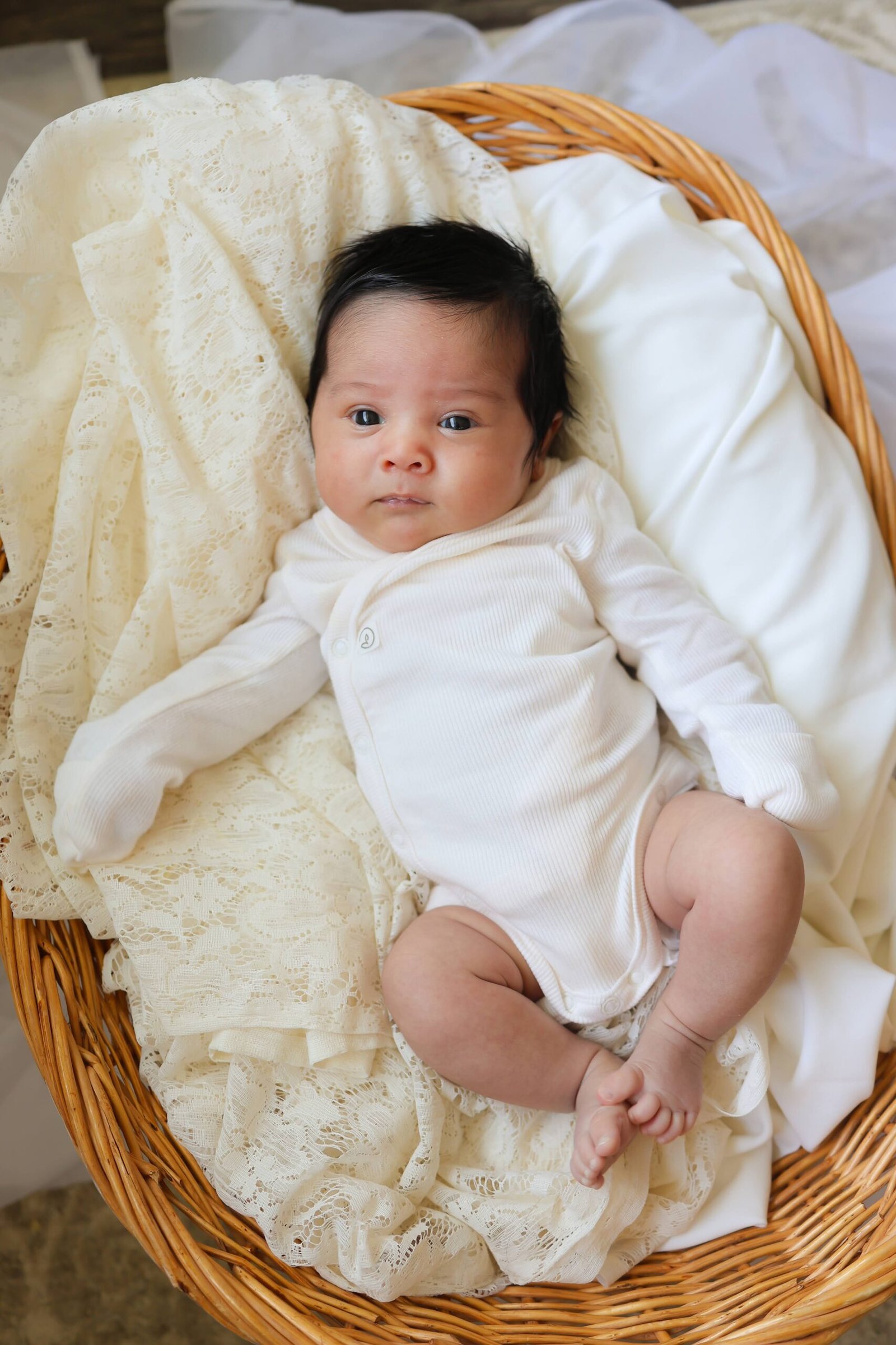 Newborn baby portrait in a wicker basket