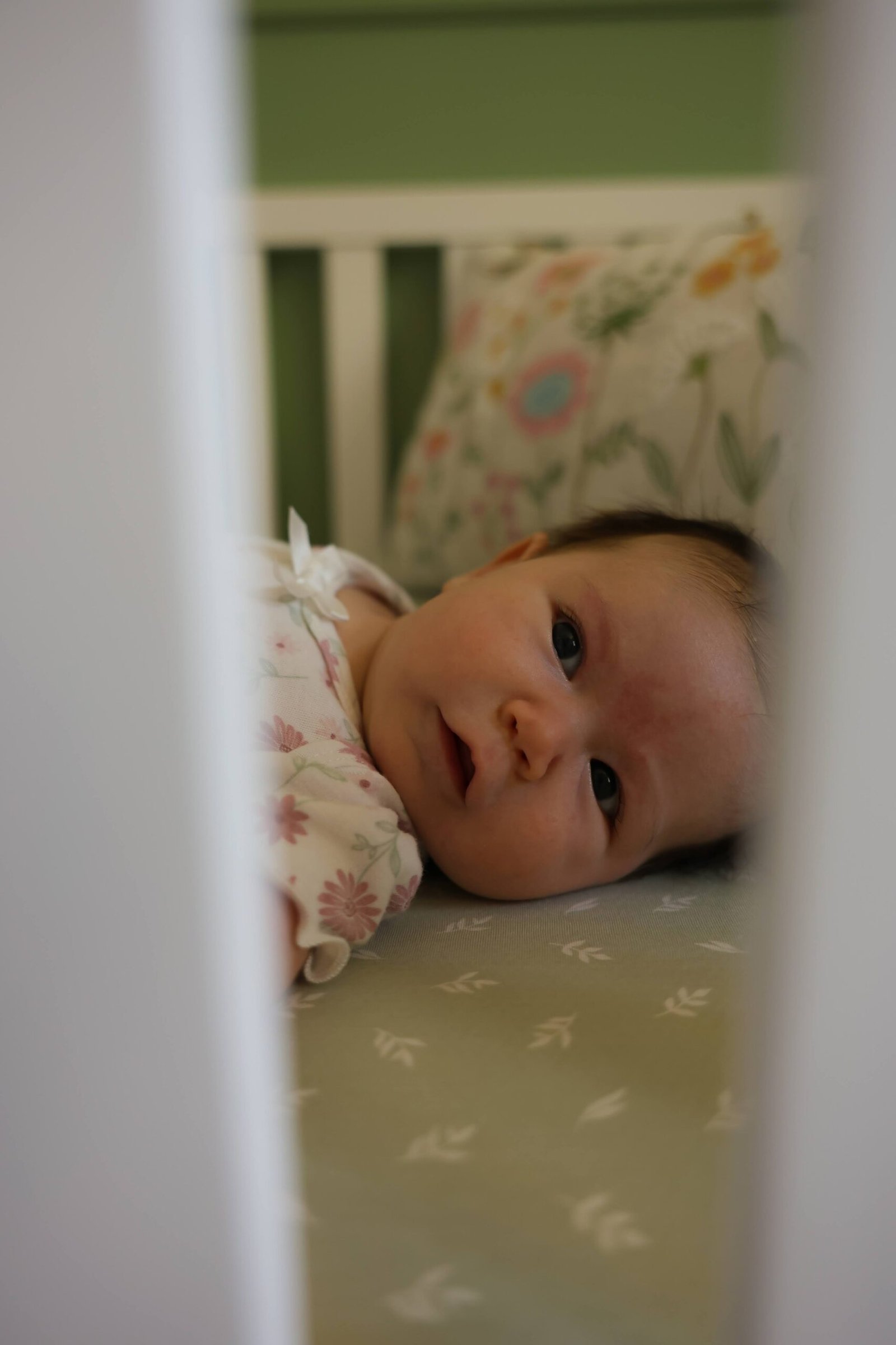 Sleeping newborn baby in a nursery crib