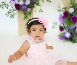 Baby portrait with floral arrangement and soft lighting