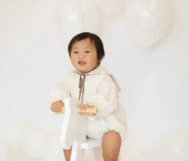 Baby sitting on stool in studio setting