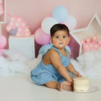 Baby sitting upright during first birthday photo session Baby sitting upright during first birthday photo session