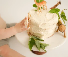 Close up of hands touching cake during cake smash session