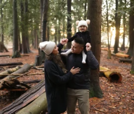 Couple embracing among tall trees during outdoor session Couple embracing among tall trees during outdoor session