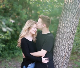Couple embracing near tree during outdoor portrait Couple embracing near tree during outdoor portrait