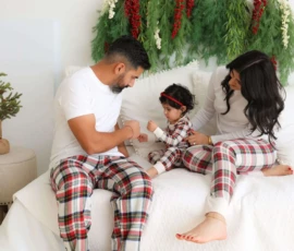 Couple in matching plaid pajamas holding baby scaled 1 Couple in matching plaid pajamas holding baby scaled 1