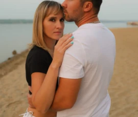 Couple standing close together during sunset portrait Couple standing close together during sunset portrait