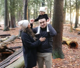 Couple standing close together in forest hugging Couple standing close together in forest hugging