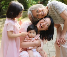 Family gathered closely smiling during outdoor portrait Family gathered closely smiling during outdoor portrait
