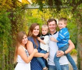 Family of five standing together outdoors smiling Family of five standing together outdoors smiling