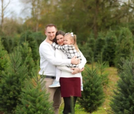 Family portrait at tree farm in winter coats scaled 1 Family portrait at tree farm in winter coats scaled 1