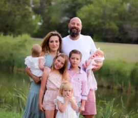 Family standing together in grassy field Family standing together in grassy field