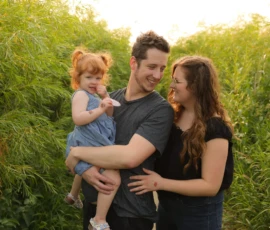 Family standing together outdoors holding child Family standing together outdoors holding child