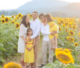 Family walking through sunflower field together Family walking through sunflower field together