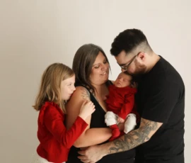 Parents hugging children closely during family portrait Parents hugging children closely during family portrait