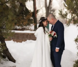 Winter wedding couple embracing outdoors in snowy landscape Winter wedding couple embracing outdoors in snowy landscape