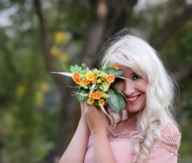 Woman holding flowers during outdoor portrait session