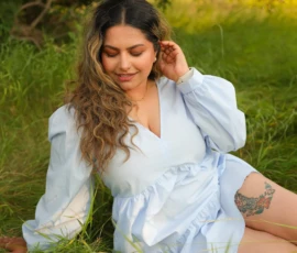 Woman sitting in grass during outdoor portrait session