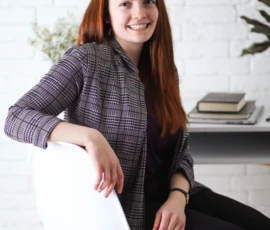 Woman sitting on stool during relaxed indoor portrait session