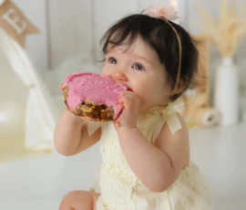 baby girl eating donut studio scaled 1